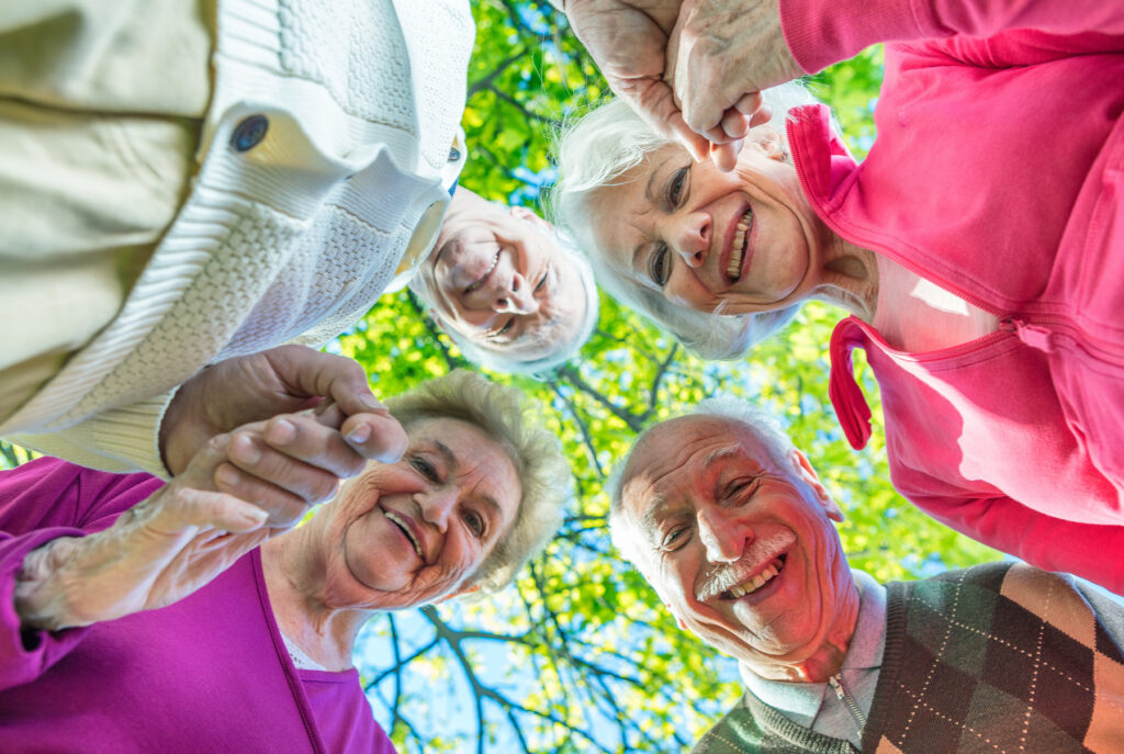 Upward view of two elder couples smiling