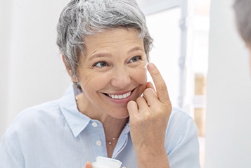 Woman applying face cream