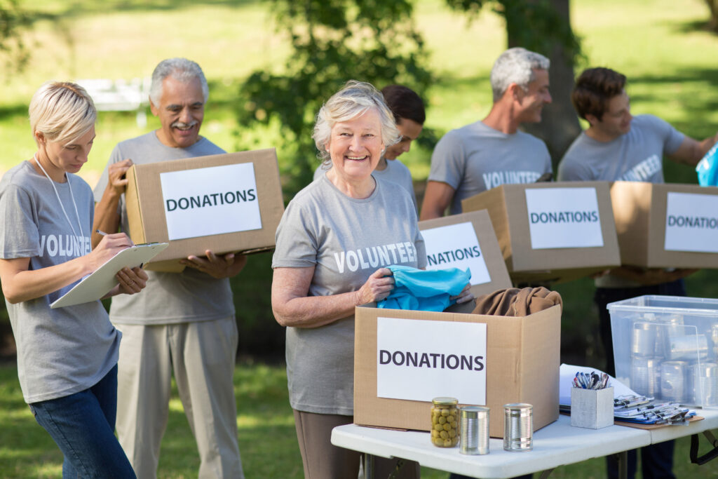 Volunteers holding donation boxes