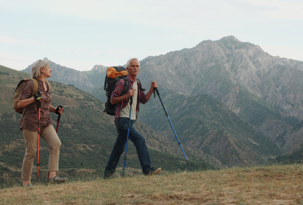 Older couple on hike with mountain in the background