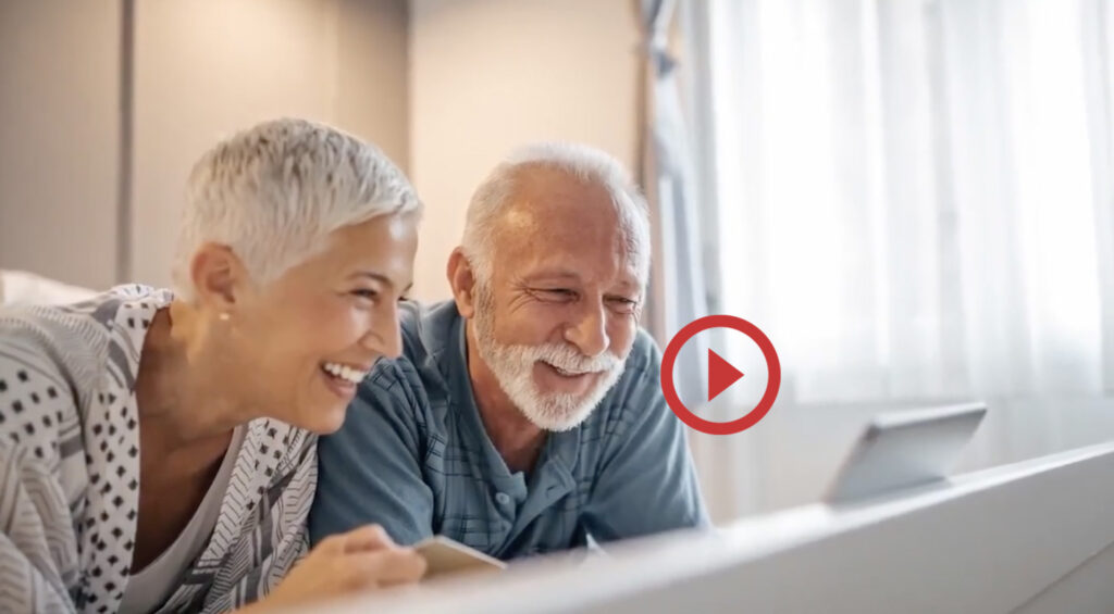 Older couple smiling while on video call