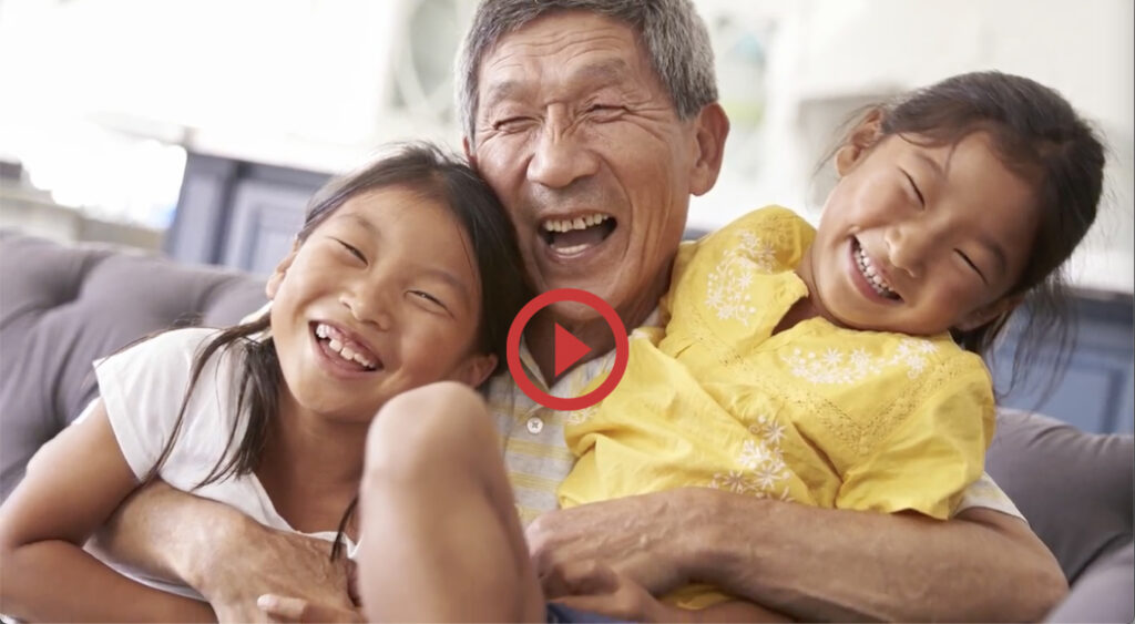 Grandfather laughing with young grandchildren